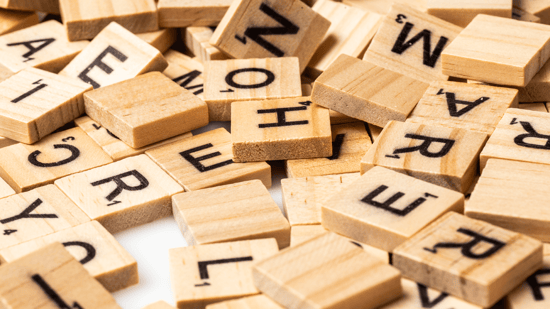 A pile of wooden blocks that each have a letter and a subcript number on them