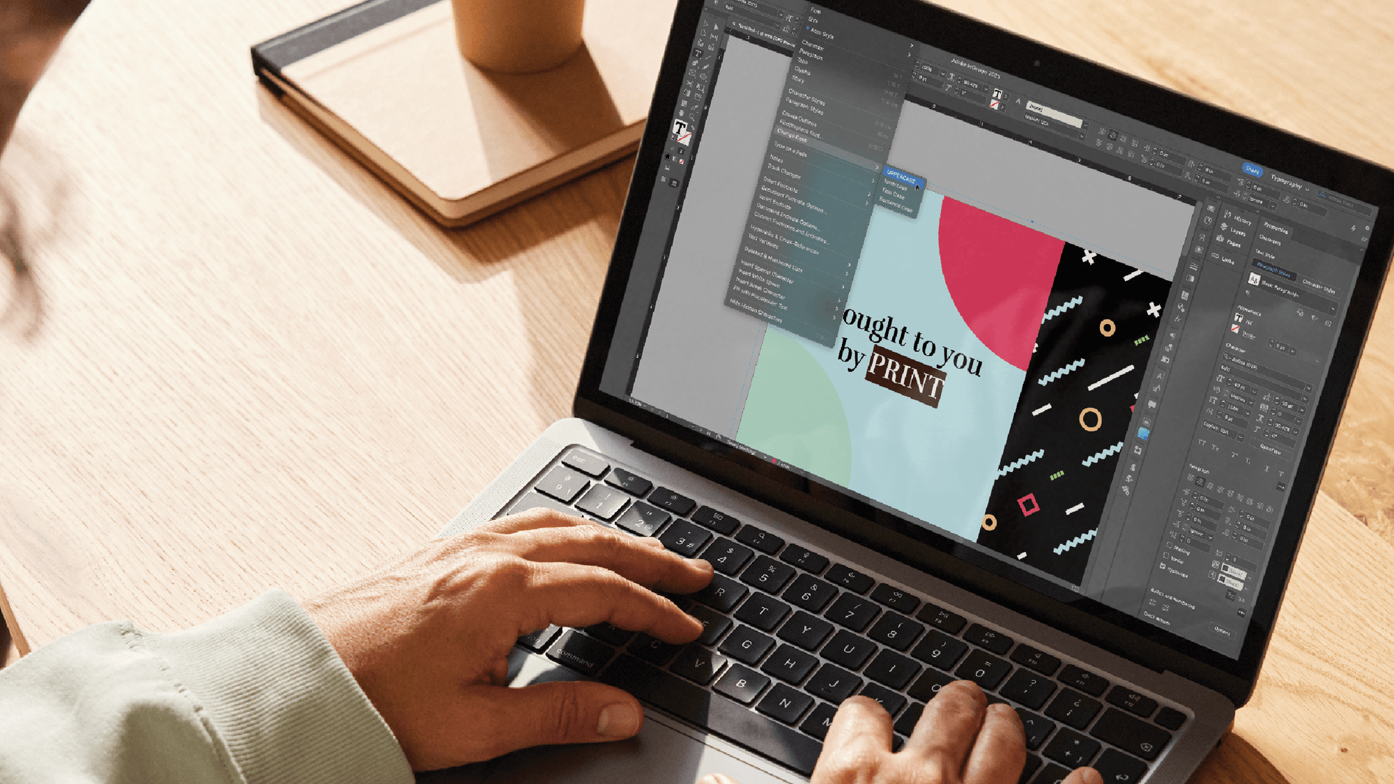 A designer using an image editing program on their laptop