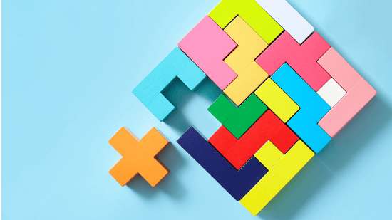 multi colored wood puzzle in the shape of a square