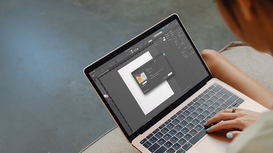 A designer using a image editor program on their laptop