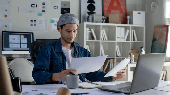 Man at his desk looking at papers