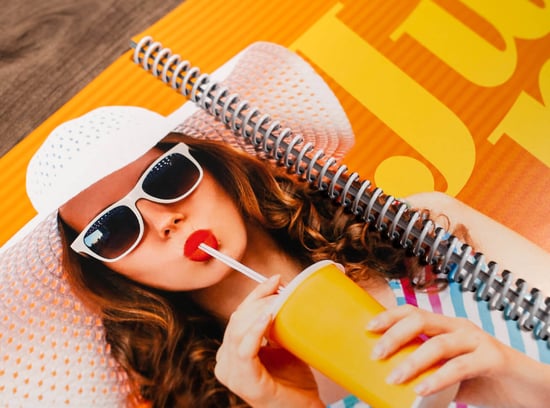 Executive planner spiral booklet with a woman in sunglasses drinking from a straw