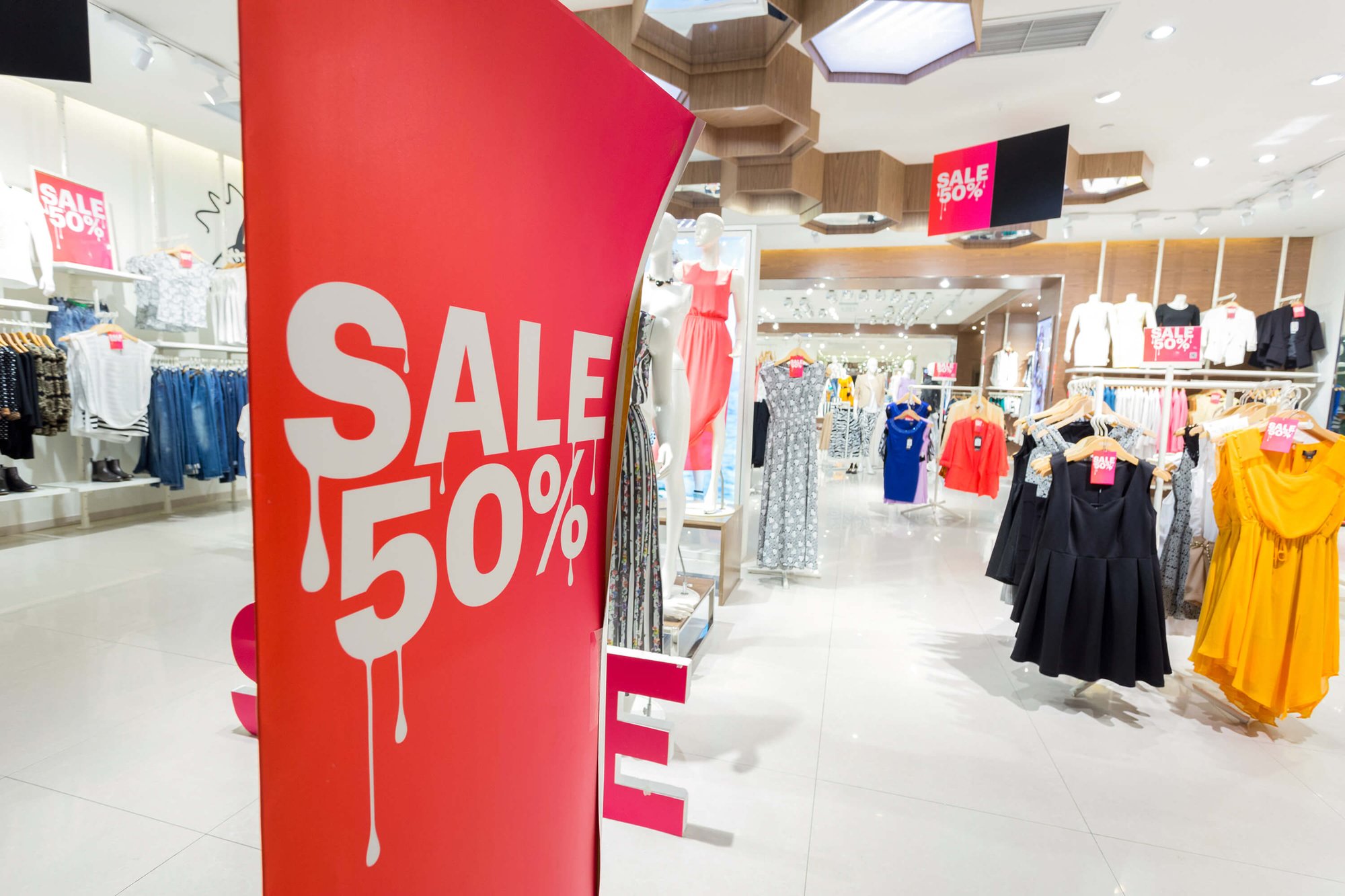 50% off retail display banner in a clothing retail store