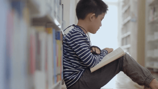 young boy reading a book