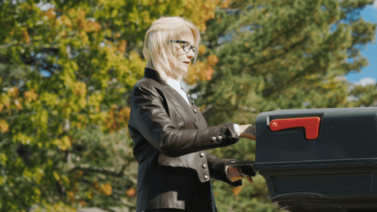 woman opening a mailbox